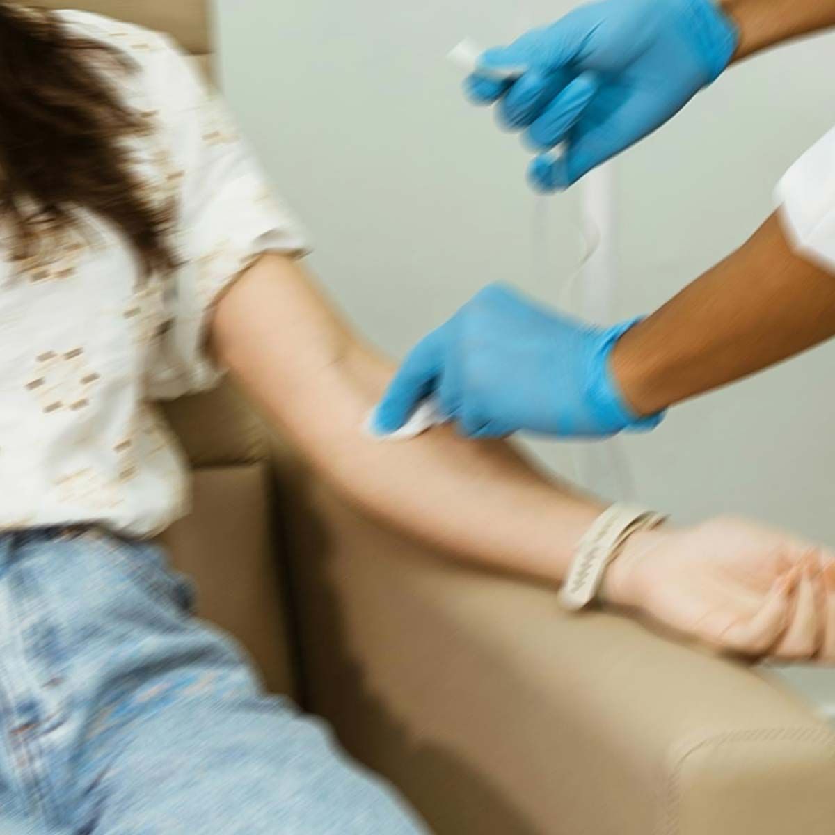 A woman getting her blood drawn in-office with motion blur