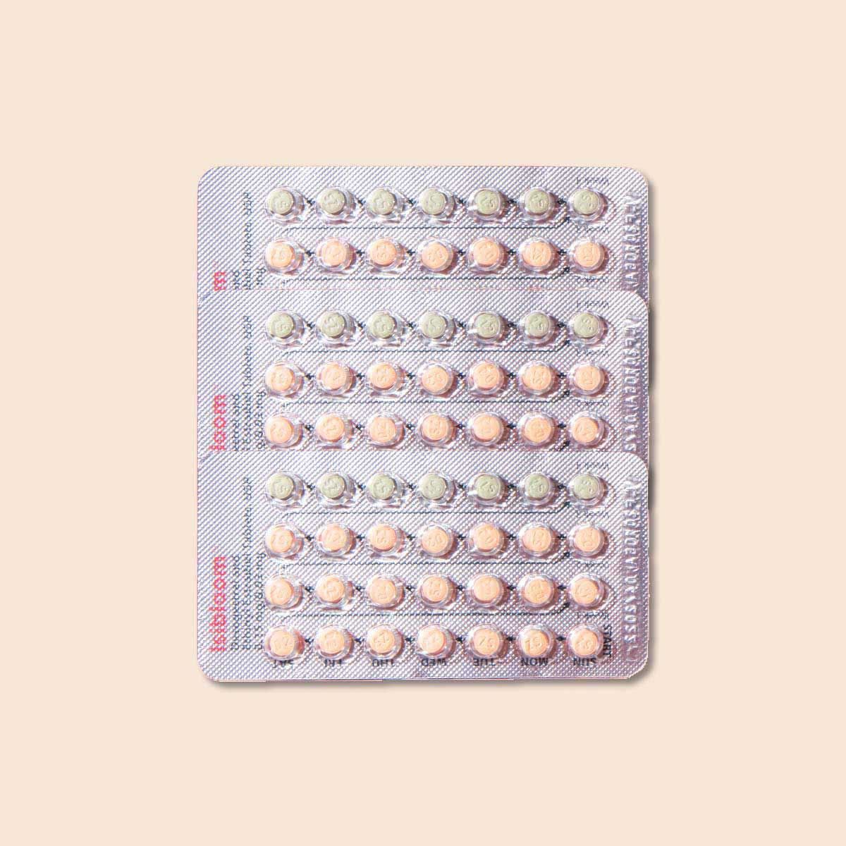 Packet of birth control pills on a cream background