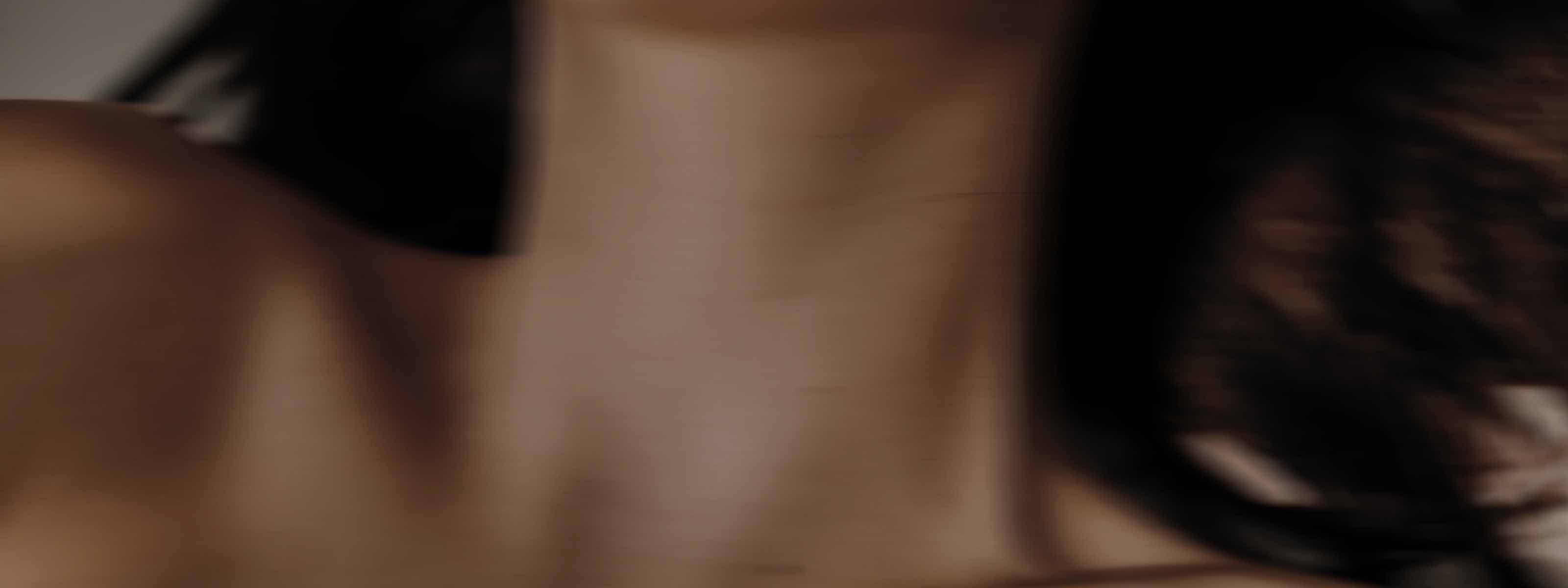 Blurred close-up of a person’s neck and hair