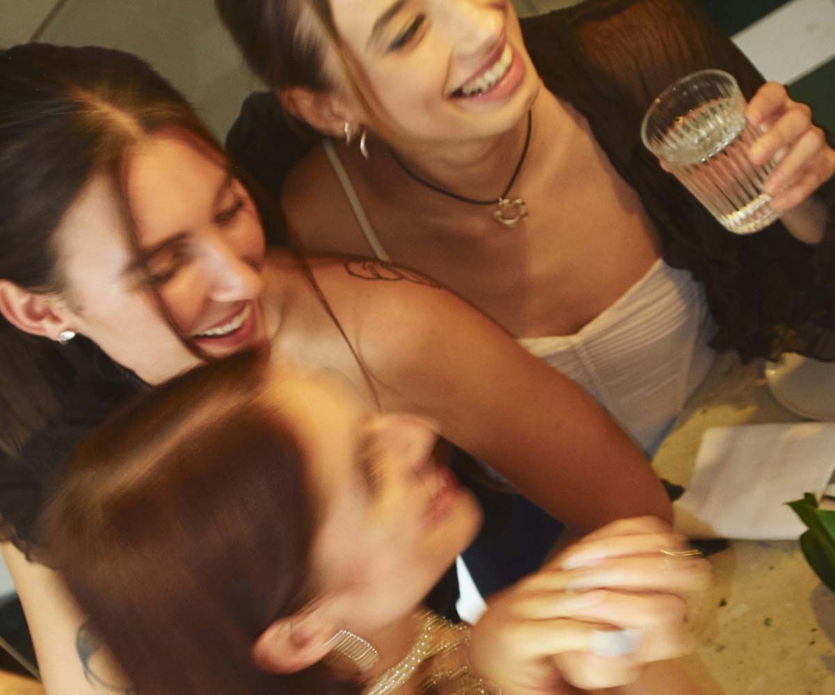A group of smiling women at a social event