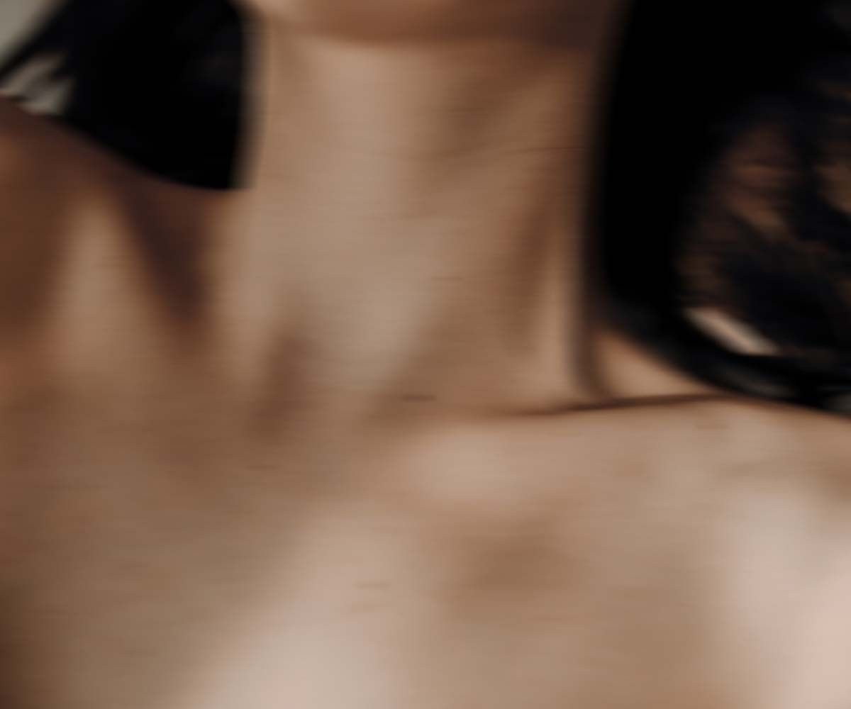 A close up of a woman's décolleté with motion blur