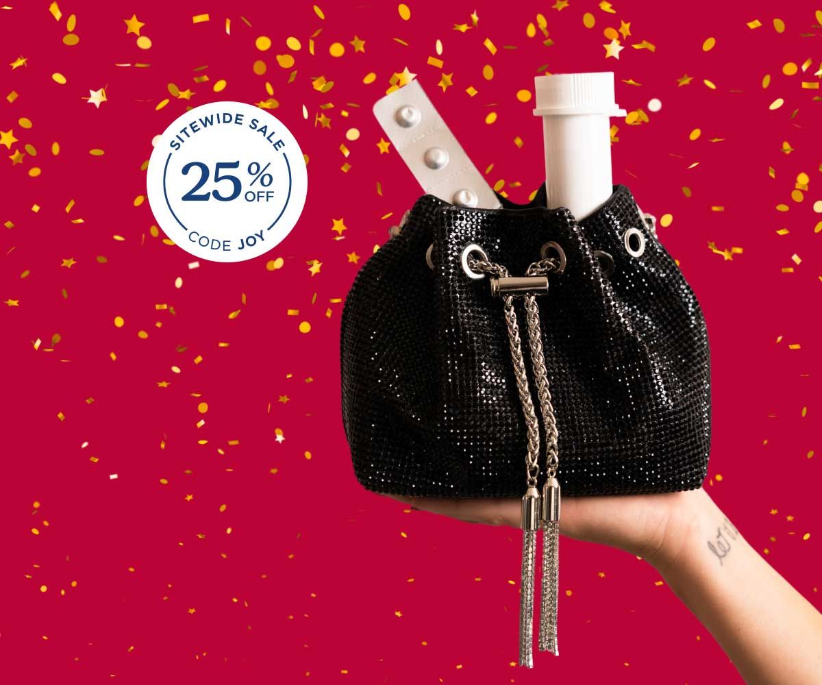 A woman's hand holding a black glittery bag with medications popping out of the top and a red and gold confetti background