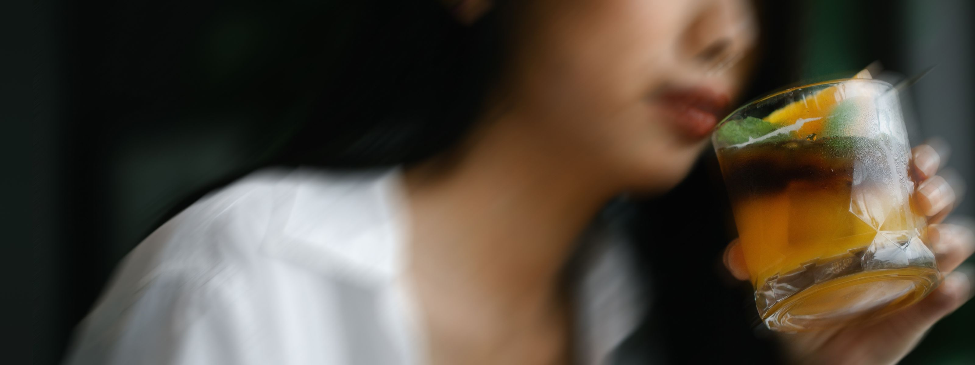 portrait image of a woman drinking an alcoholic beverage