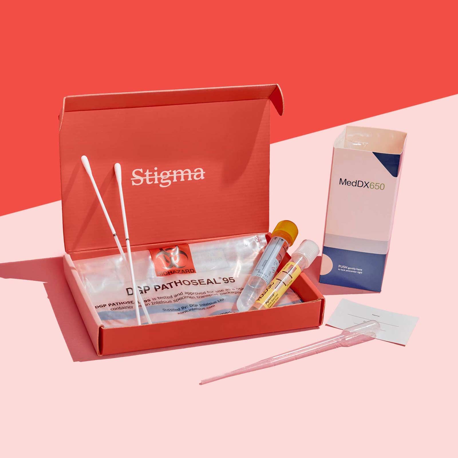 A Wisp diagnostics box with sample collection supplies on a pink surface with a red background