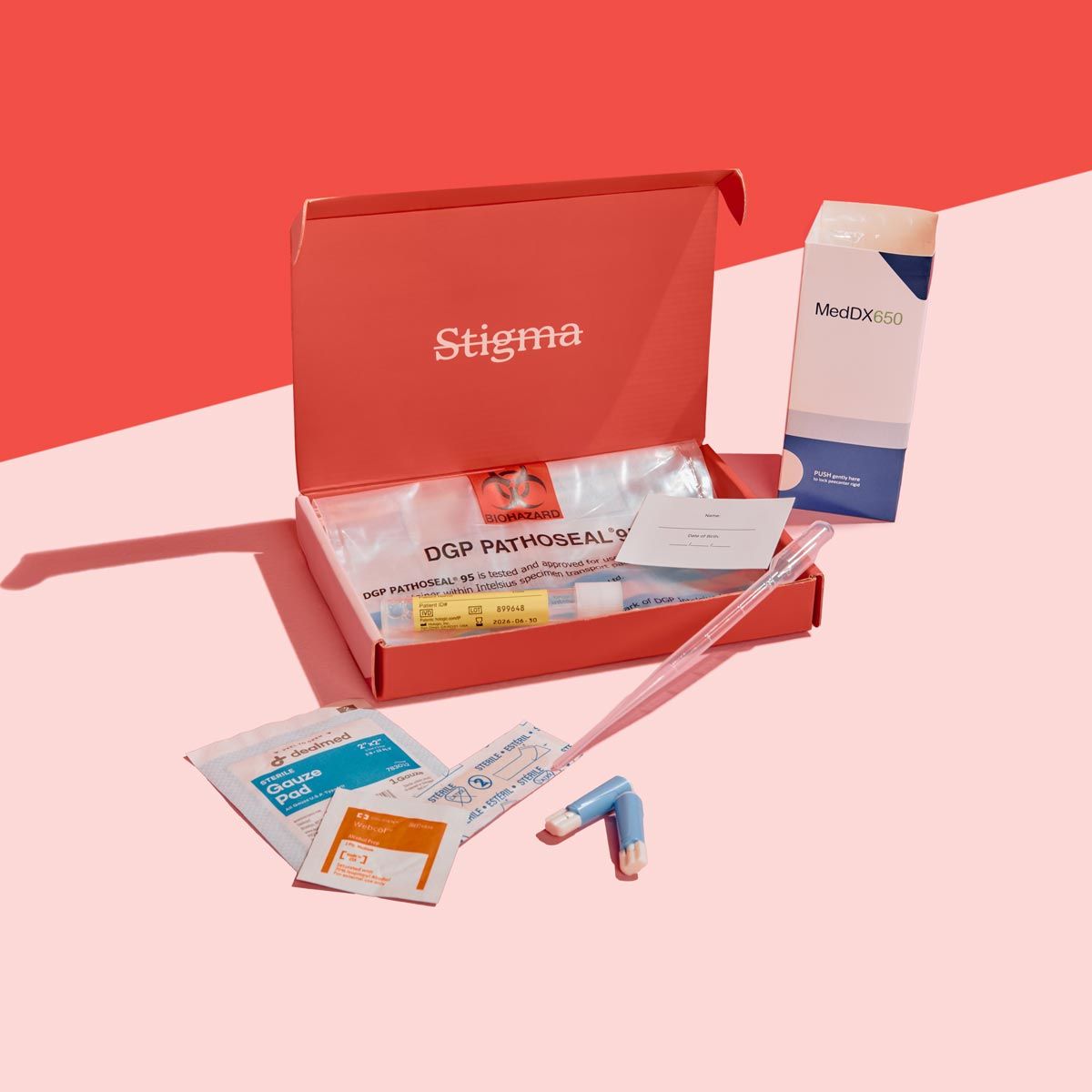 A Wisp diagnostics box with sample collection supplies on a pink surface with a red background