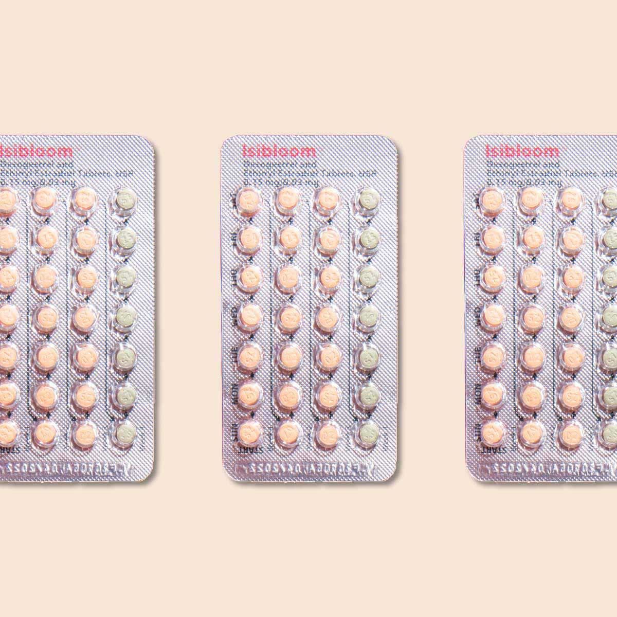 3 packets of birth control pills on a cream background