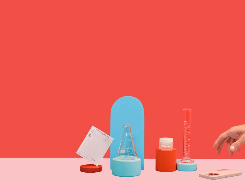Man's hand reaches for phone sitting next to lab slip, reproductive health medications, and test tubes on colorful geometric background