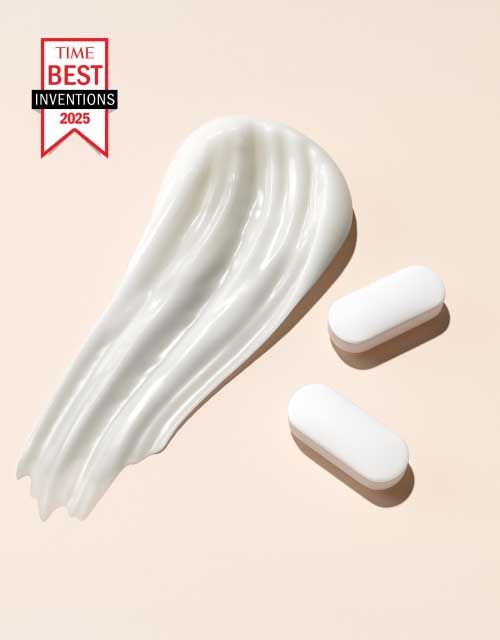 A cream swatch and 2 pills on a cream surface