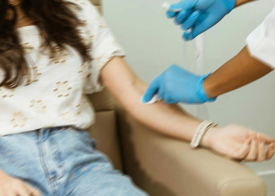 A woman getting her blood drawn in-office with motion blur