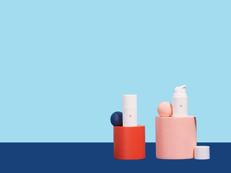 Two bottles of Wisp Metronidazole Gel with colorful abstract shapes with a light and dark blue background