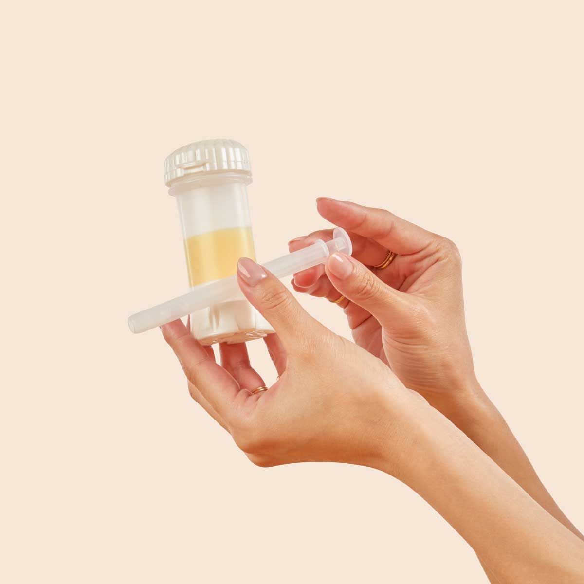 A woman holding Wisp Non-Hormonal Vaginal Moisturizer tube and applicator with a cream background