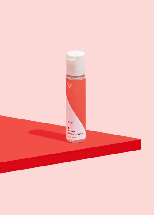 Wisp Toy Safe lube on a pink and red background