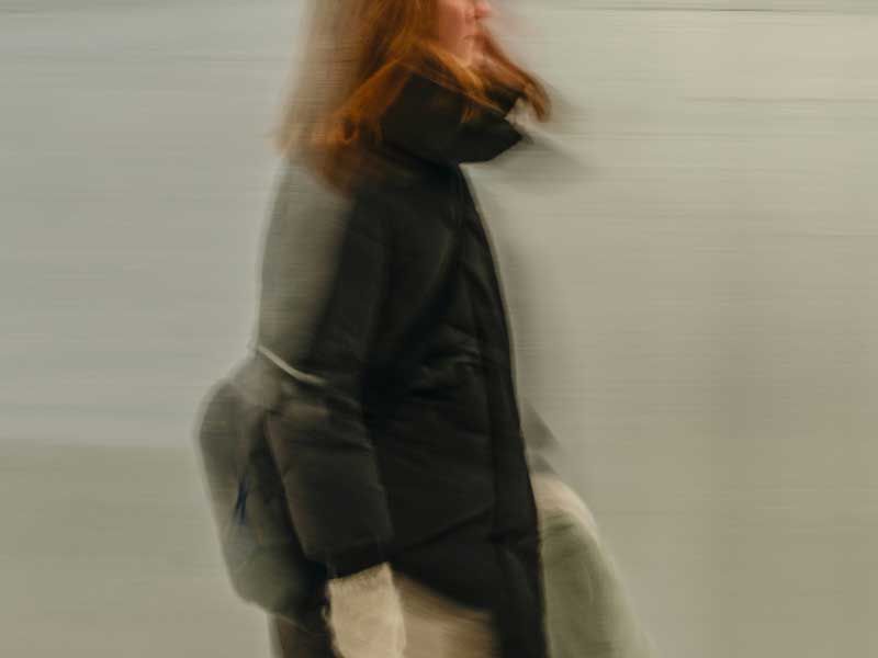 Woman in a black jacket in motion blurred portrait