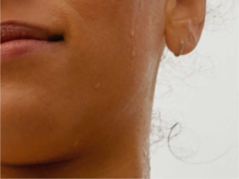 image of woman's face with sweat dripping down her cheek