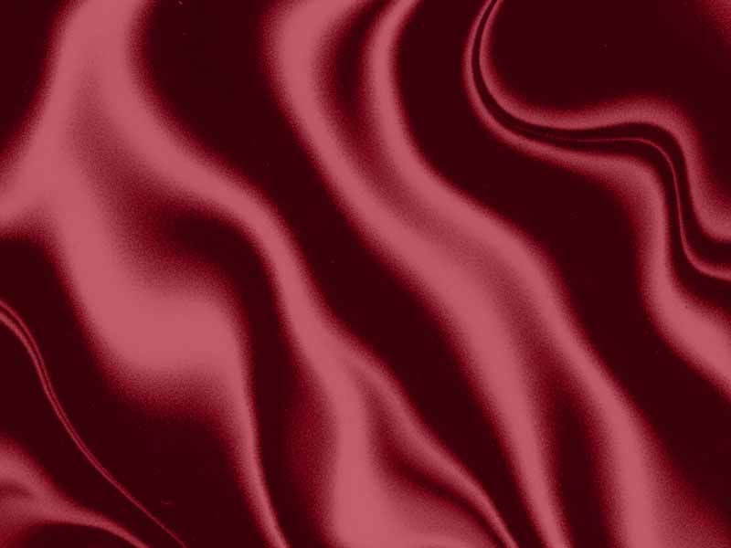 Flowing deep red satin fabric with soft folds and a silky sheen.