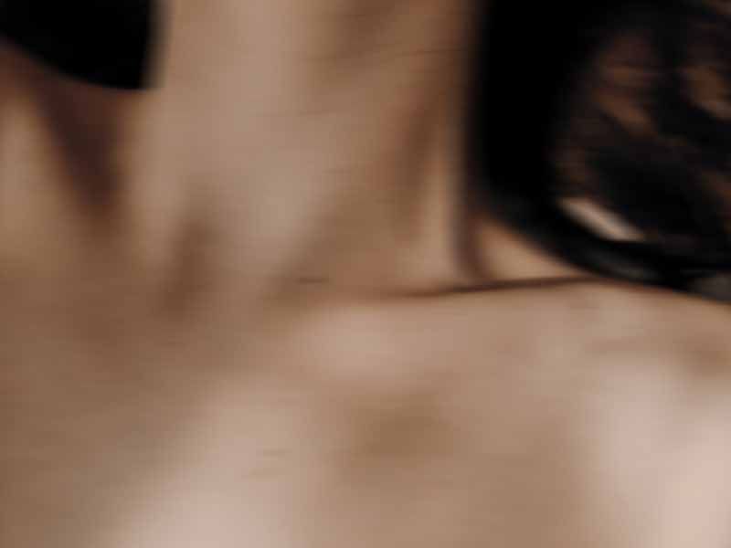 Blurred close-up of a person’s neck and hair