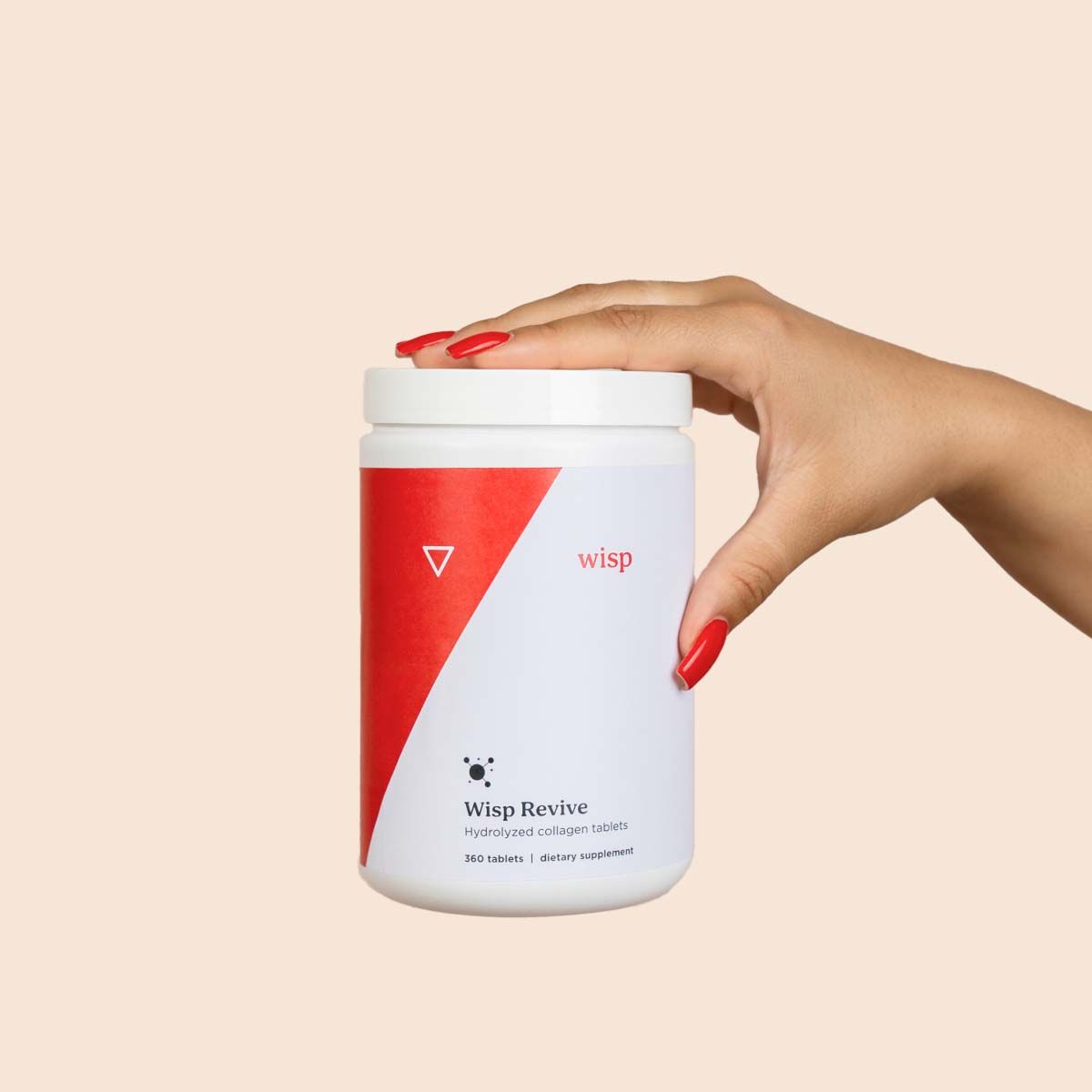 A woman's hand holding Wisp Revive Collagen with a cream background