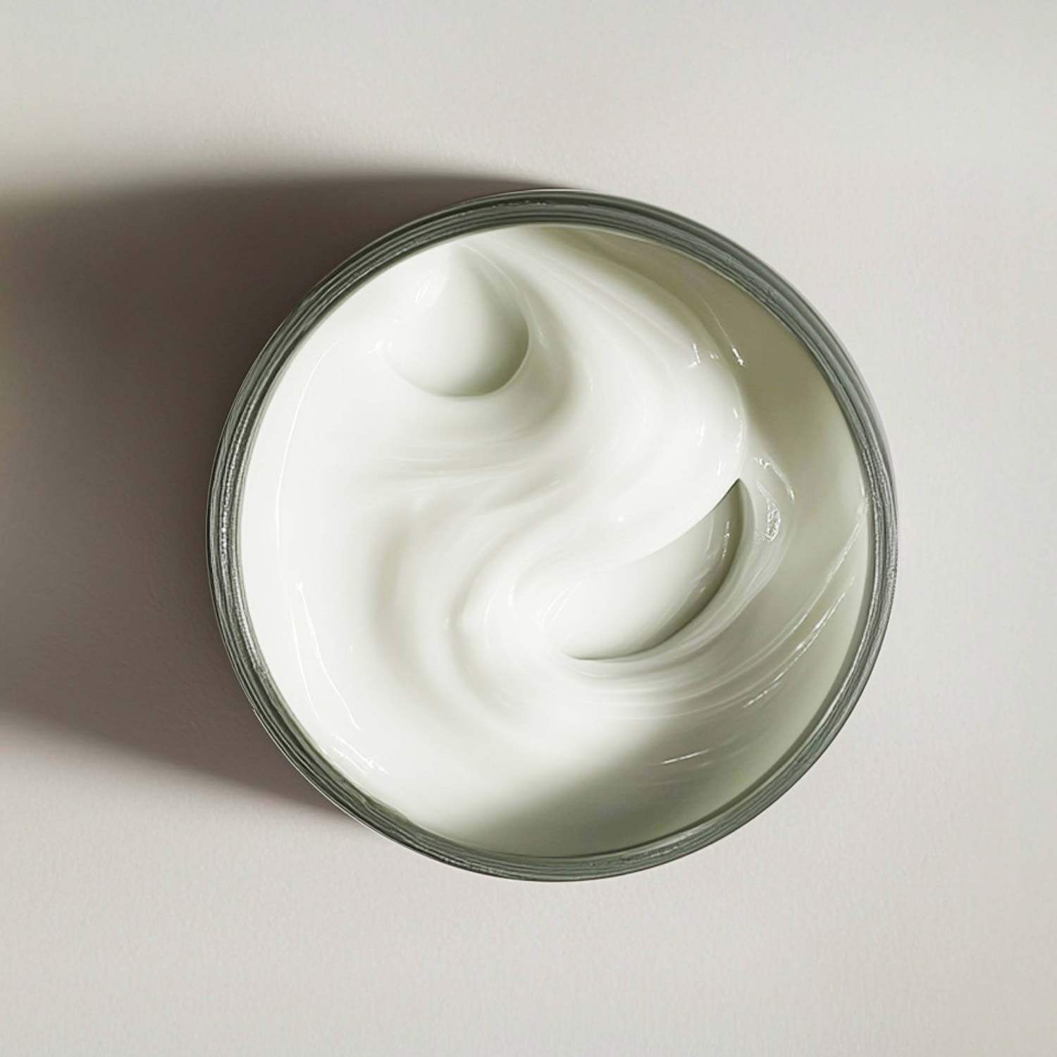 An open tub of The Crown Pleaser by Stripes Beauty showing the creamy texture