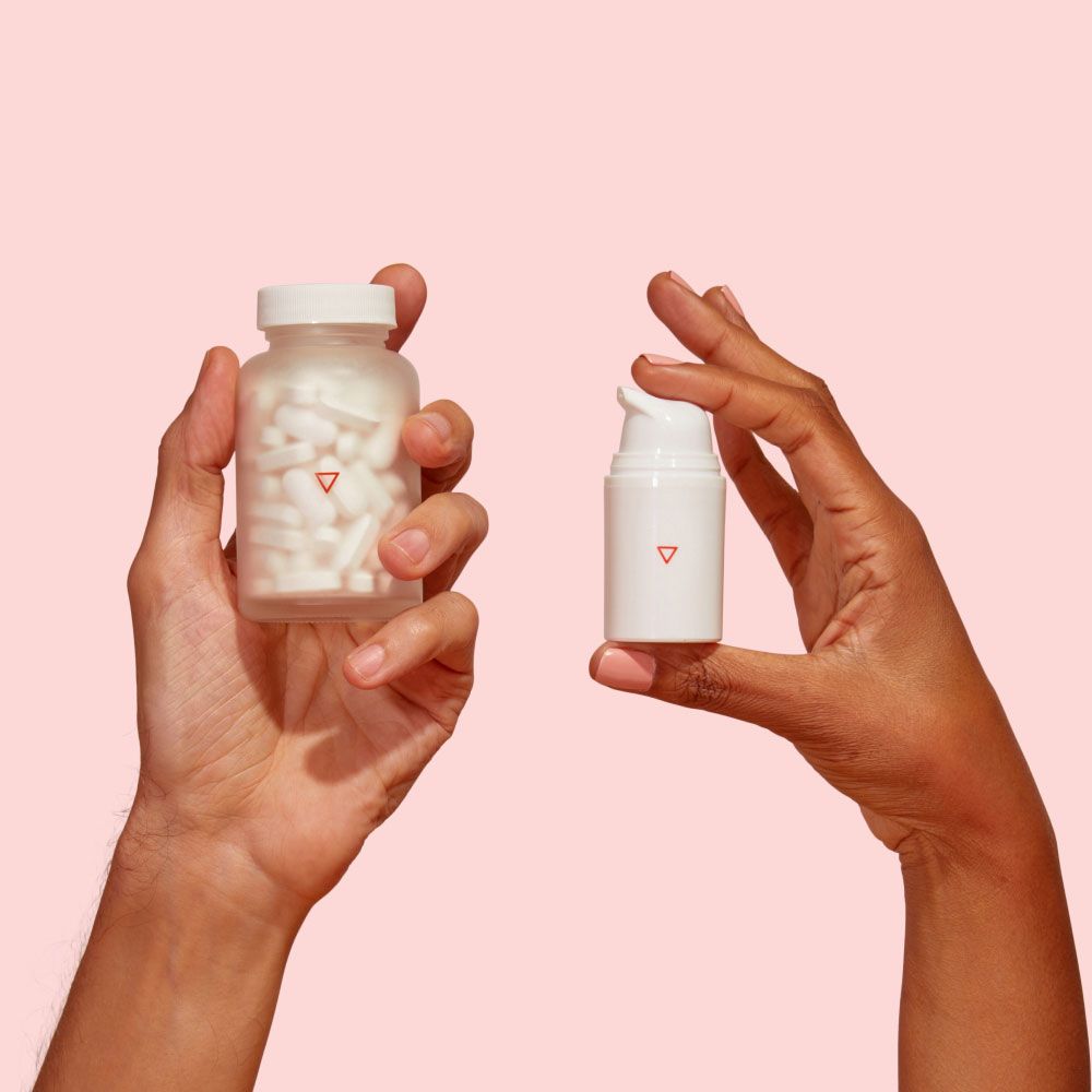 A man's hand holding a Wisp glass jar and a woman's hand holding a Wisp plastic pump bottle in front of a pink background