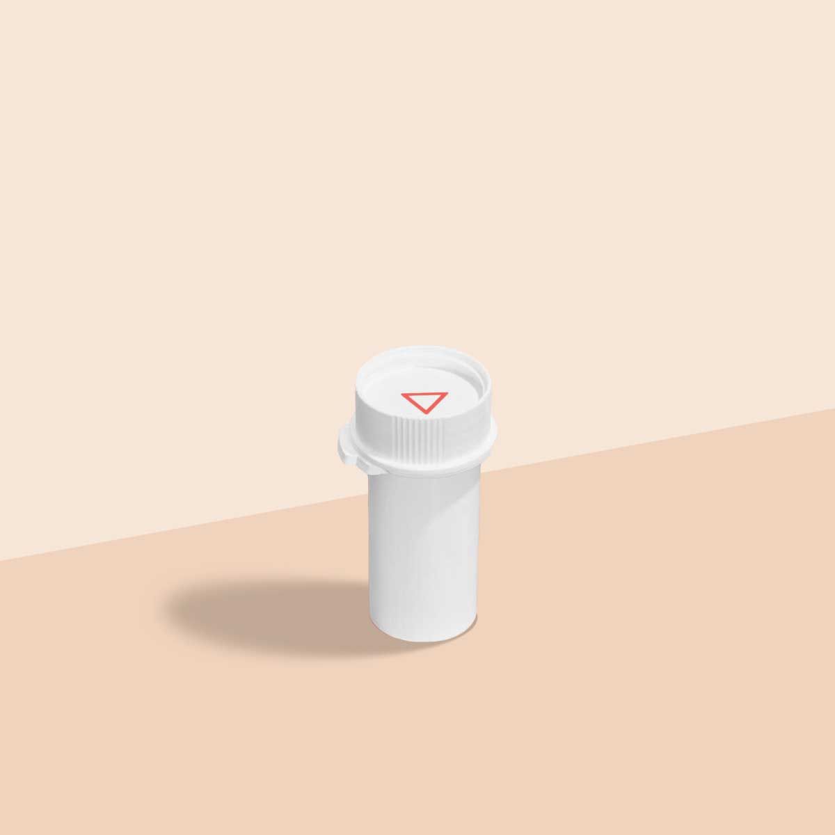 A Wisp pill vial on a cream surface