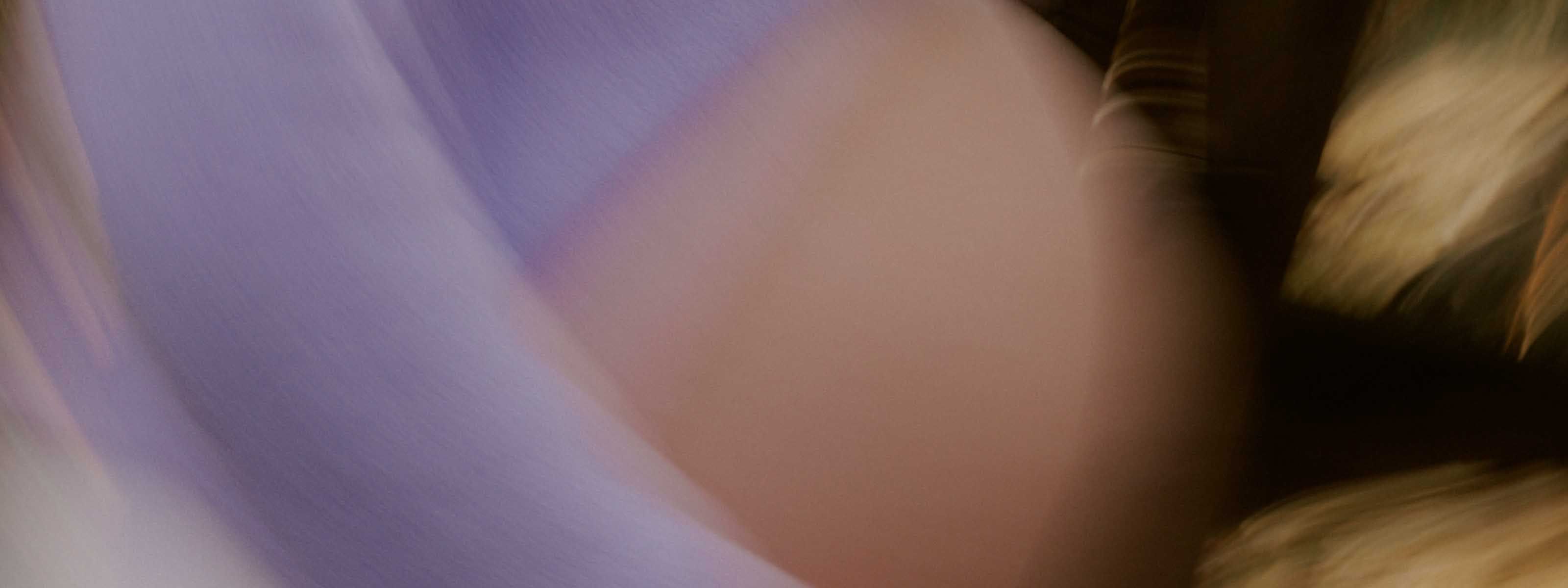Soft, blurred close-up of a pregnant torso in motion.