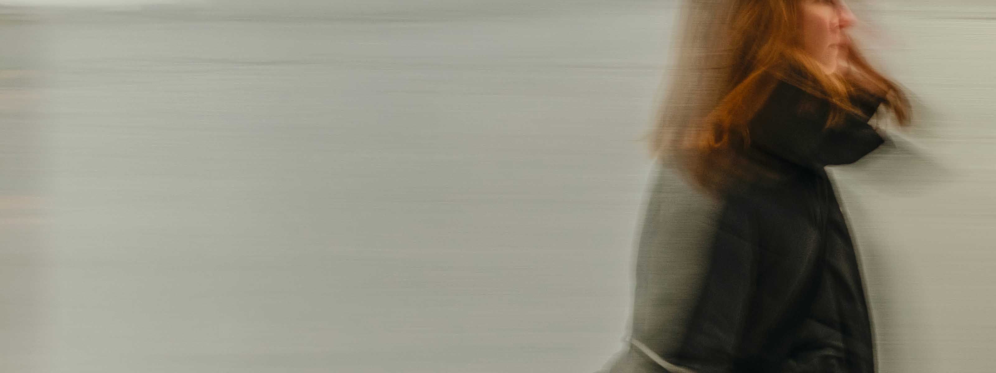 Woman in a black jacket in motion blurred portrait