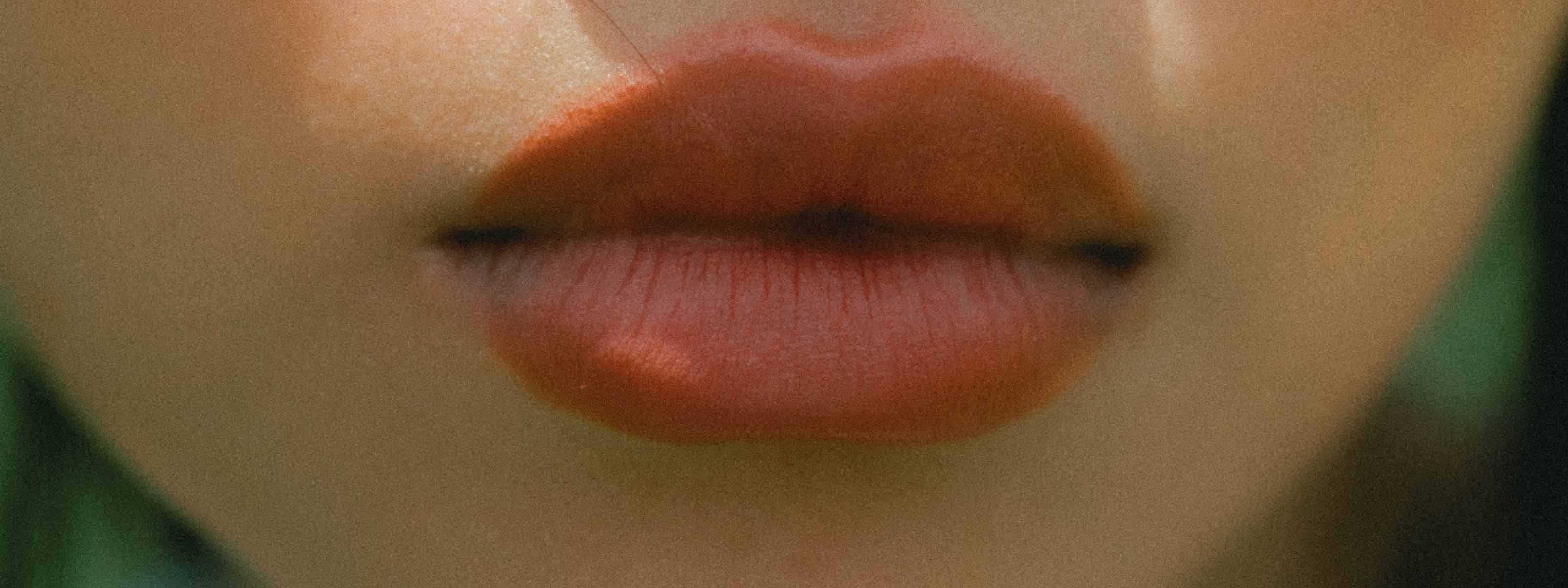 A fuzzy close up of a woman's lips