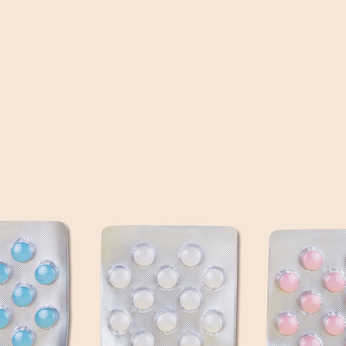 3 packets of Levora birth control pills on a cream background