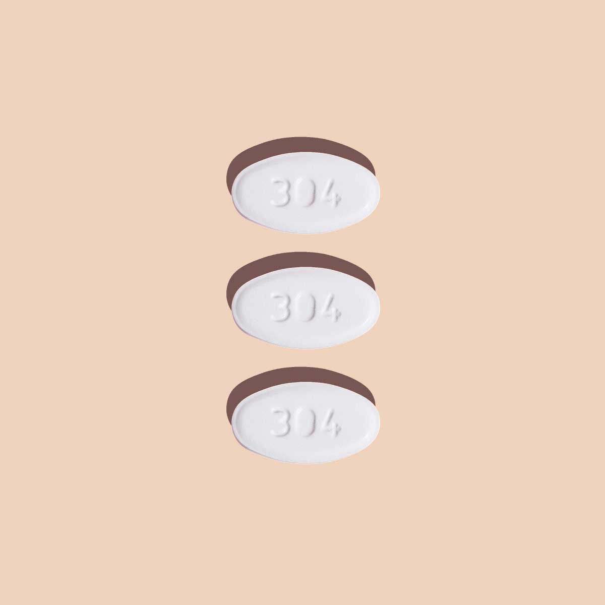 Single Norethindrone Acetate pill to delay your period on a cream background