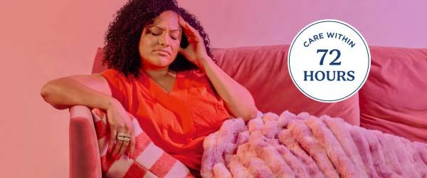 a woman with a migraine laying on a couch on a gradient background