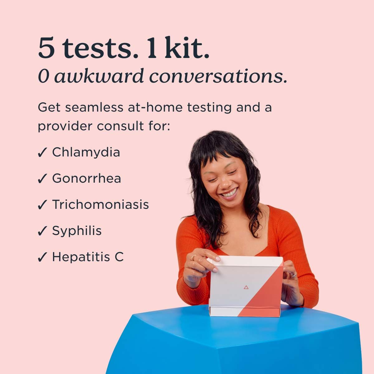 A pretty woman wearing a red shirt is opening a Wisp diagnostics kit on a blue table in front of a pink background
