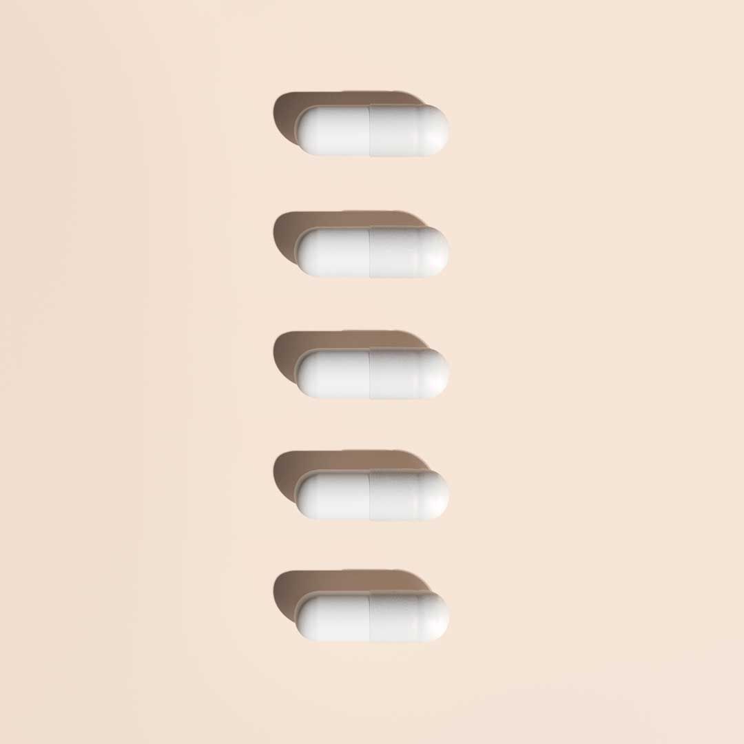 5 DMannose pills on a cream surface