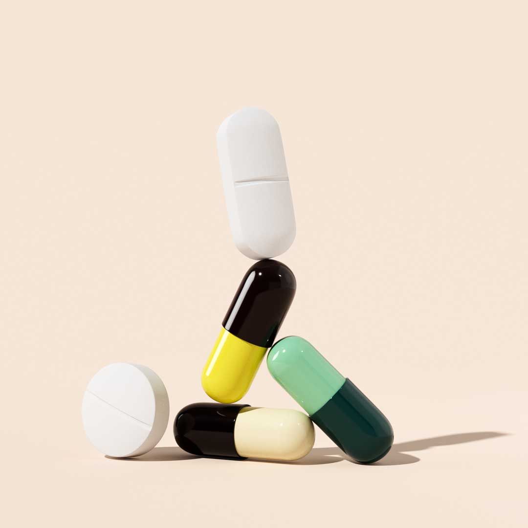 Stacked UTI Antibiotic pills on a cream surface