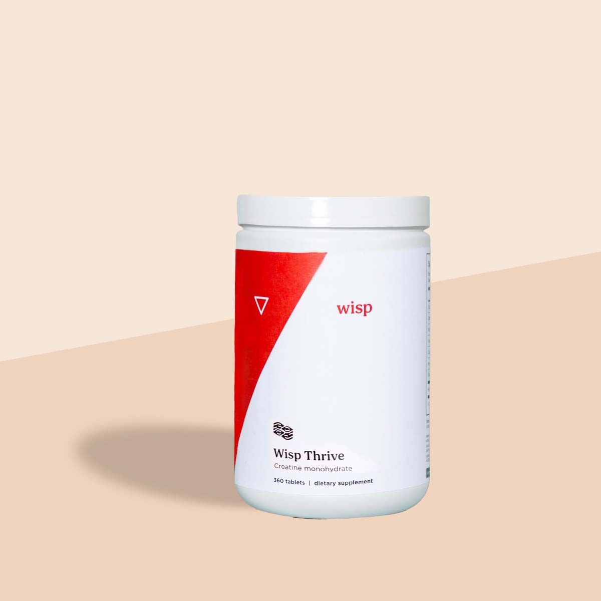 Wisp Thrive Creatine Supplement bottle on a cream surface